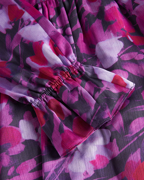 SAMMIEH-Dresses-Hello, gorgeous. SAMMIEH is the ultimate in flirty flower power. Featuring frills, cut outs and a vibrant floral print, this mini dress is just as at home with chunky boots as it is with sky high heels.The fabric of this product is made of 100% recycled polyester. Using recycled polyester helps divert plastic waste from ending in landfills and helps us to reduce our dependancy on virgin materials. Mini dress Floral print Fit and flare Long sleeved with frill cuffs High neck Zip fastening Tie